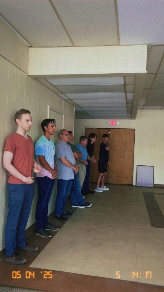 A group of men standing in a line preparing to dance