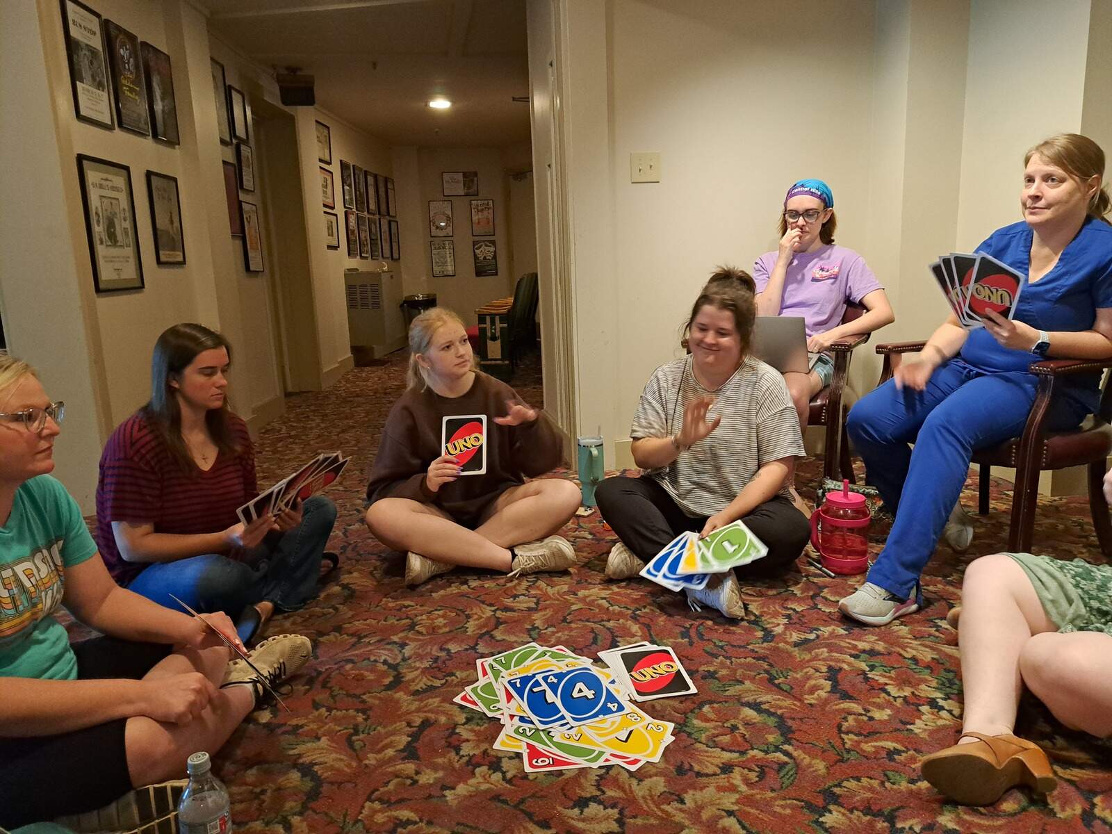People gathered in a circle playing giant uno