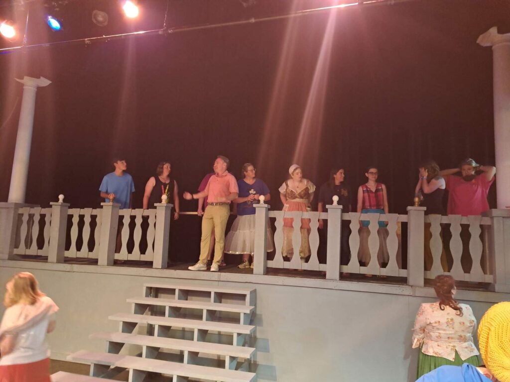 A group of people standing on a platform with stairs in front