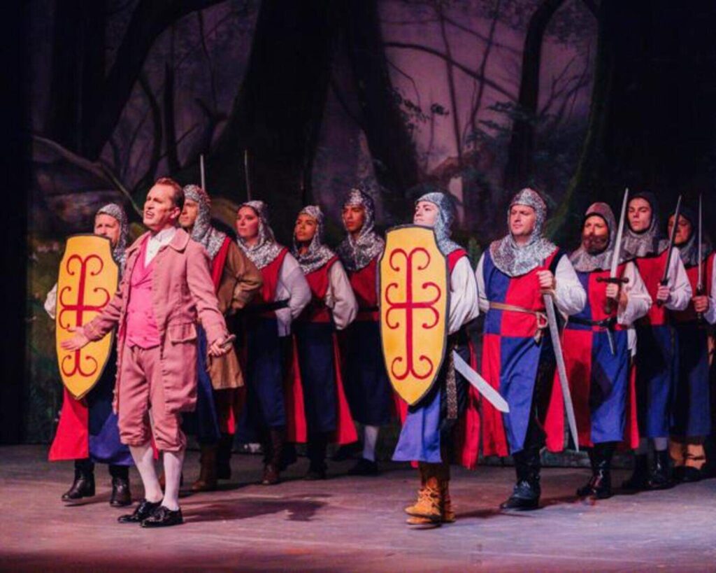 An array of knights stands around behind the Prince